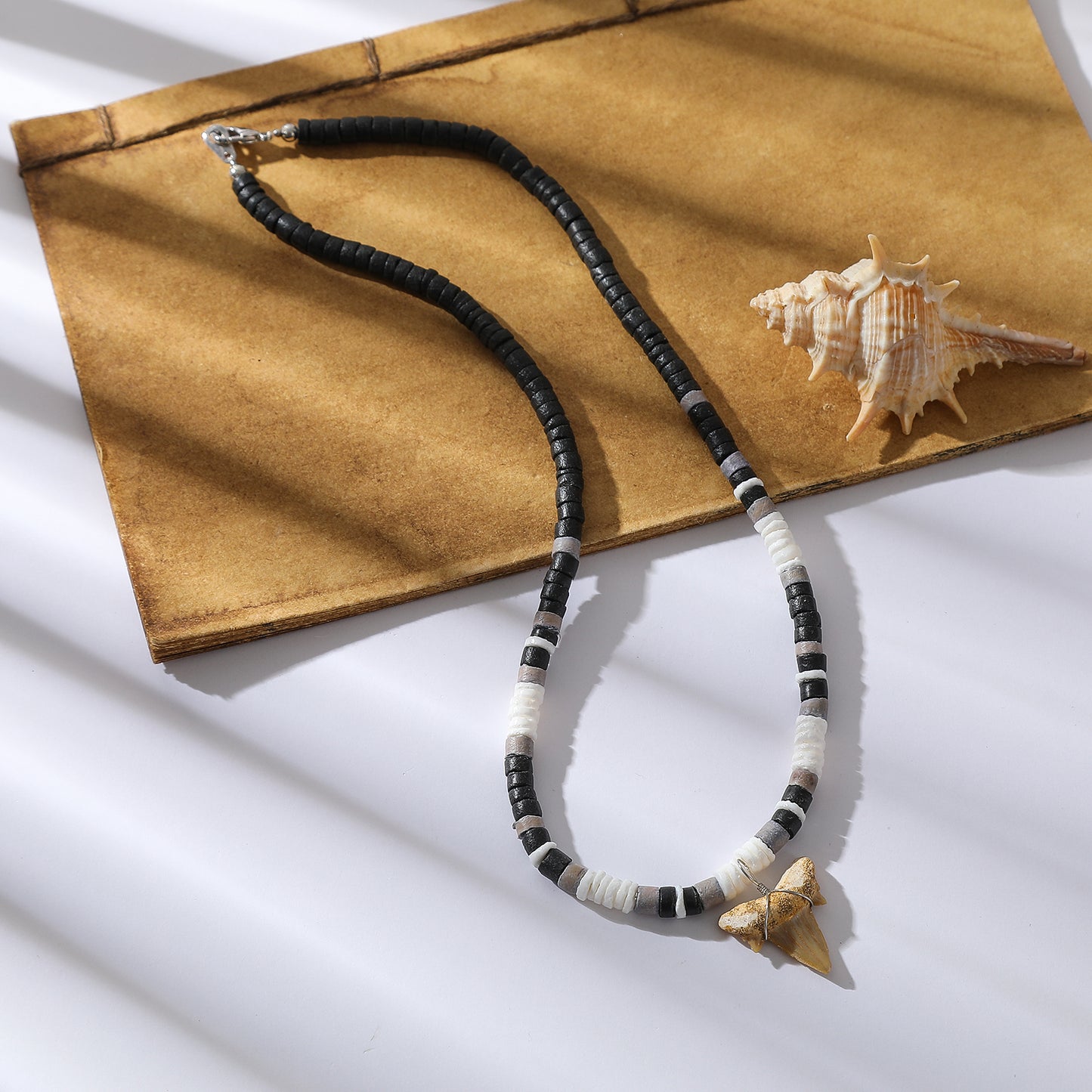 Black, White, and Grey Beaded Necklace with Natural Shark Tooth Pendant