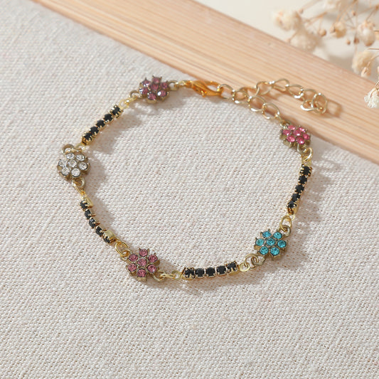 Elegant Gold Chain Bracelet with Multicolored Daisy Rhinestones & Black Accents - Chic Statement Jewelry for Women, Perfect for Everyday Wear or Special Occasions