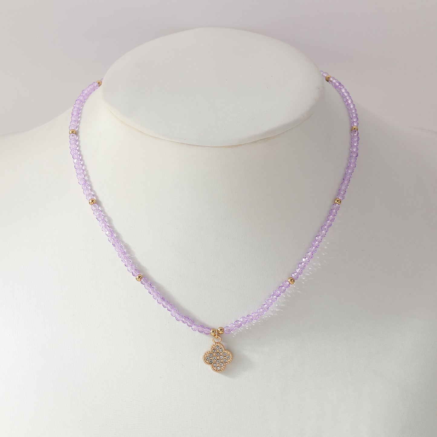 Elegant Beaded Necklace with Crystal & Gold Clover Charm - Stylish Jewelry for Women in Black, Purple, White & Pink